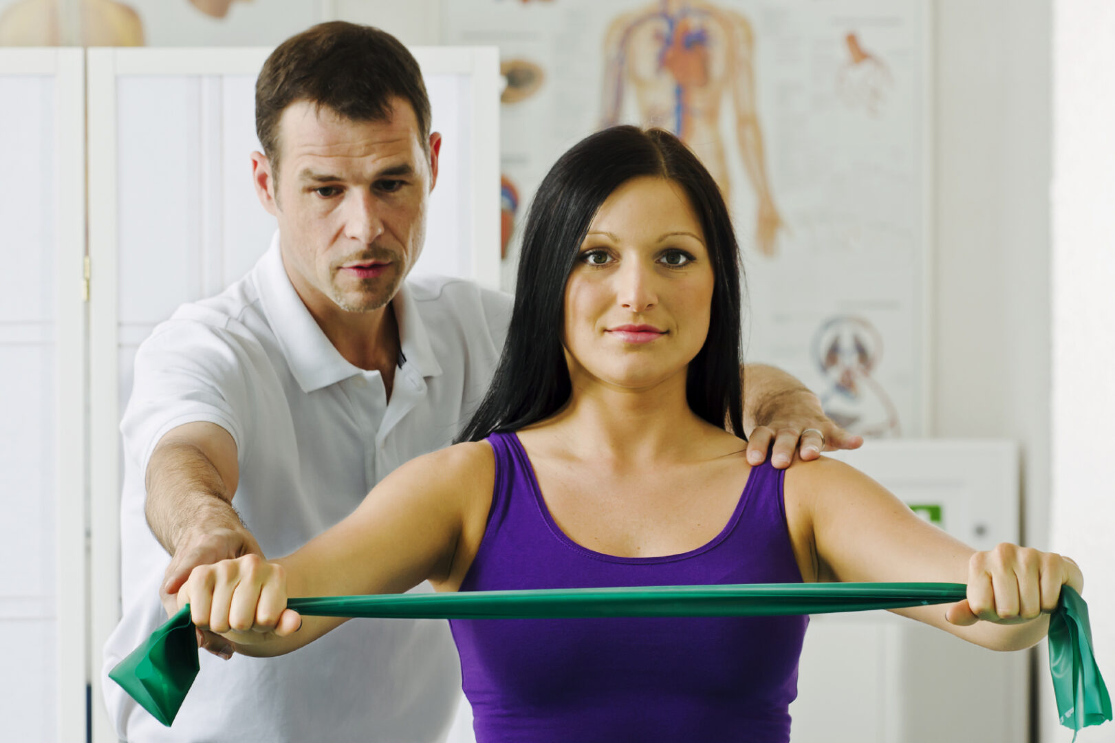 Young female at the physical therapist office getting treatment for back pain.